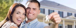 couple with a house key looking happy
