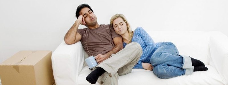 couple sitting stressed on a couch