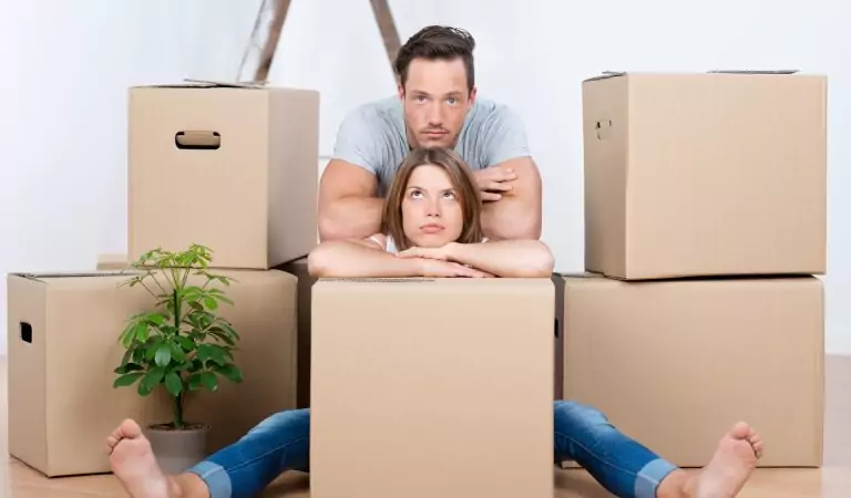 couple looking anxious inside of a house